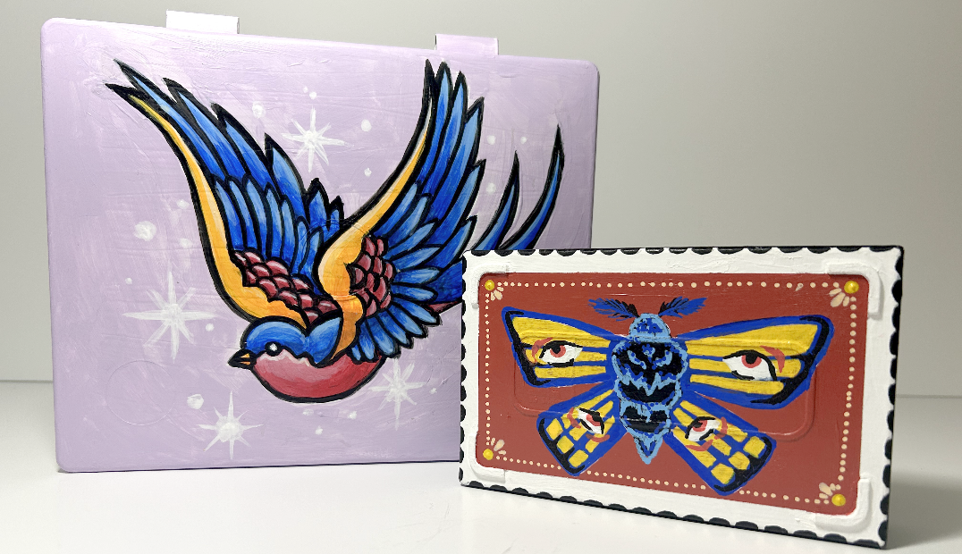 Two decorated trinket boxes. One large one with a bird on it and one smaller one with a moth.