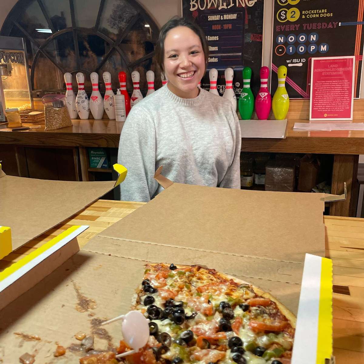 A student posing with pizza in CyBowl