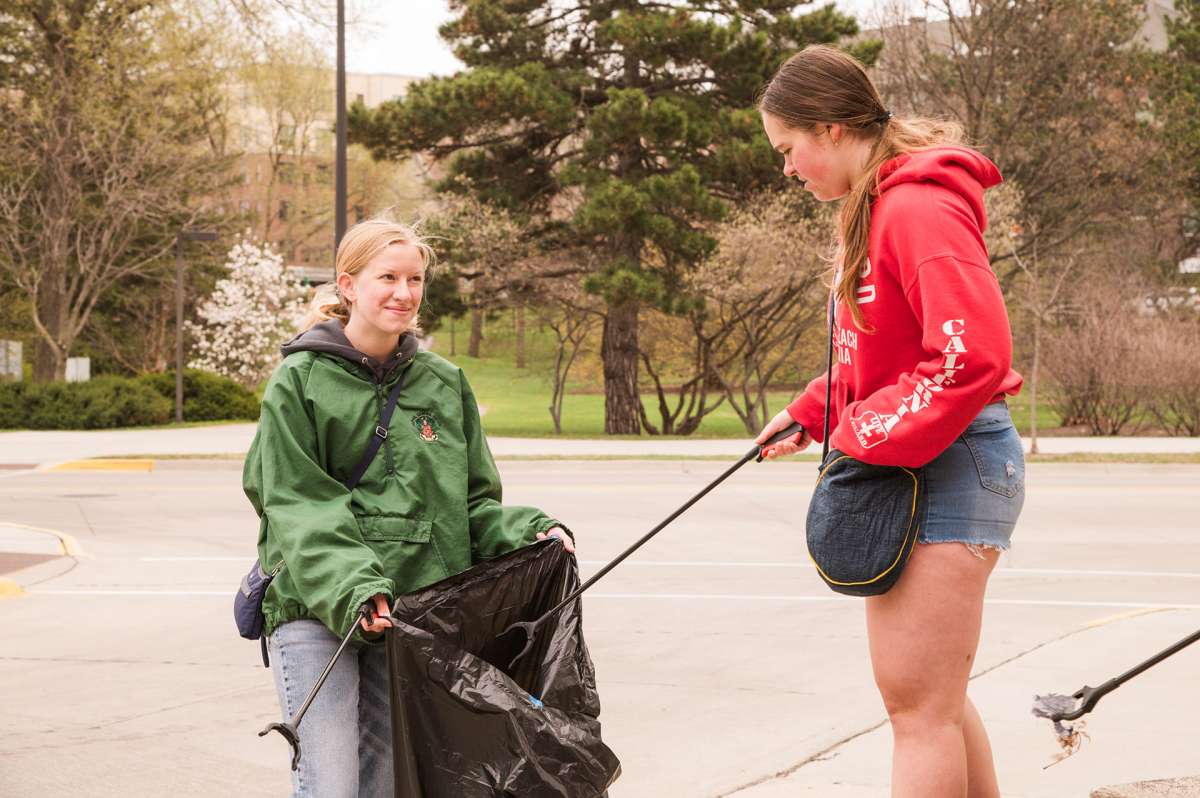 Students helping to pick up trash during campus service day