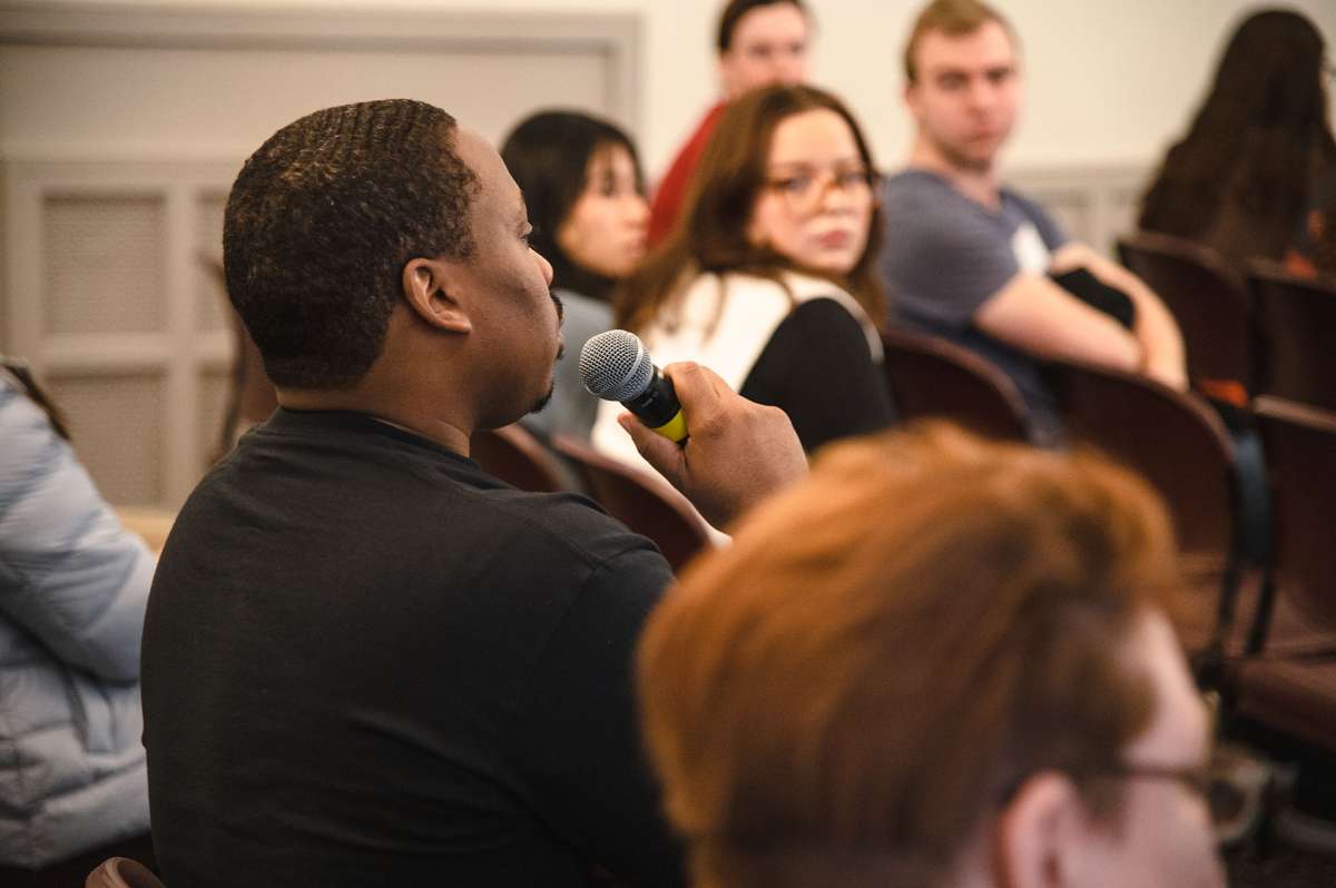 A student speaking into a microphone during a leaders workshop series