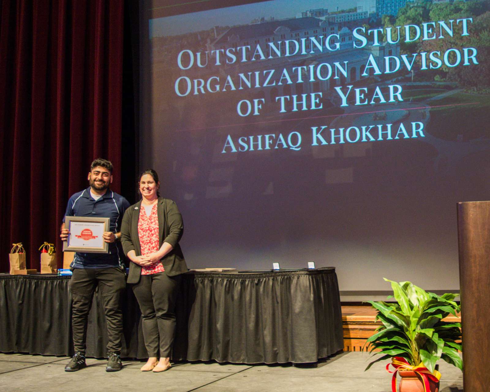 A photo of a student organization receiving an award for best advisor of the year.
