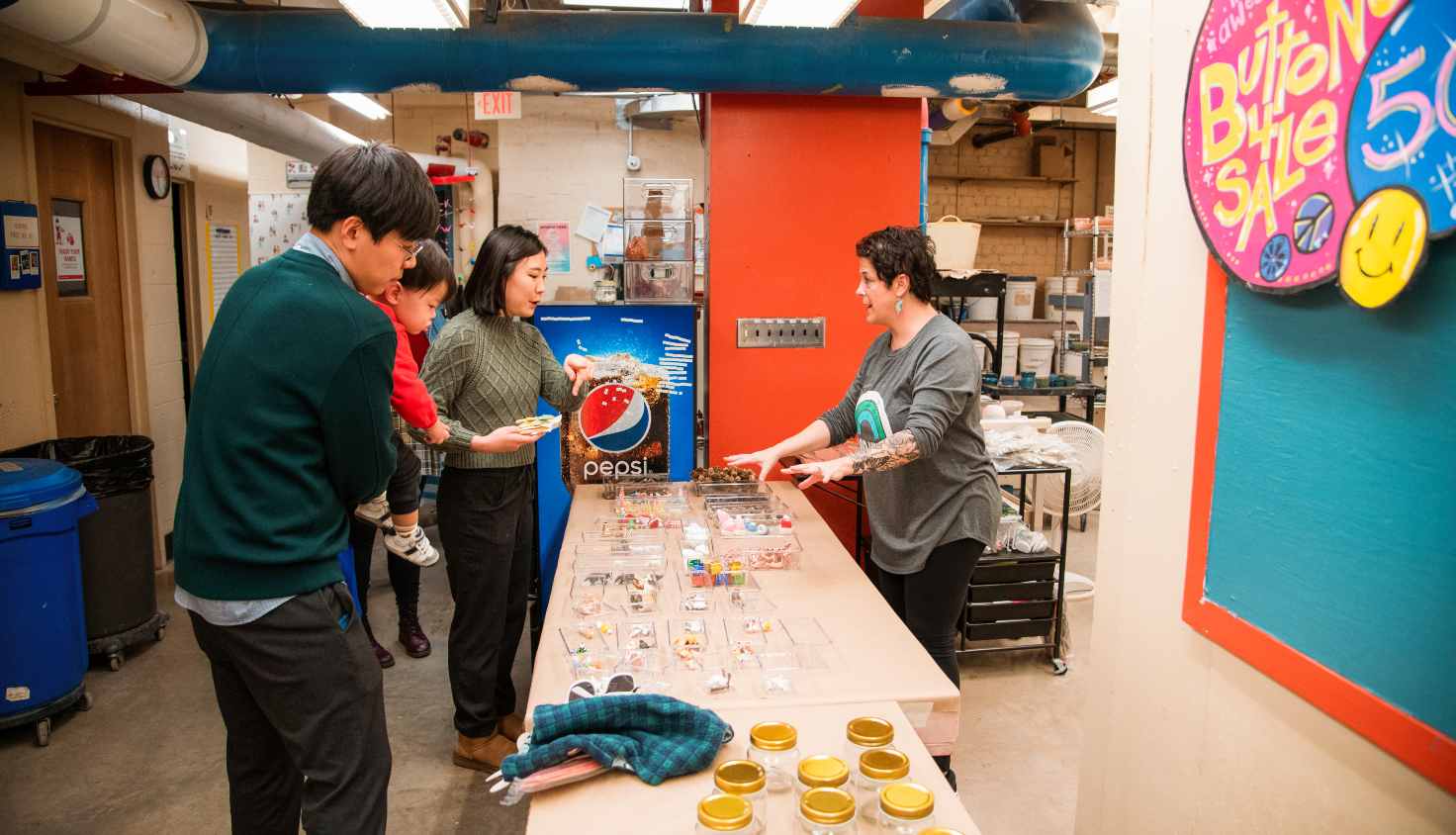 family choosing items for a craft with staff member helping them choose